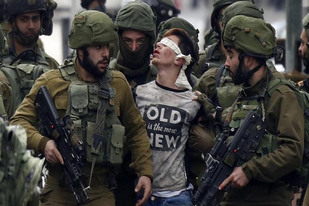 Israeli occupation soldiers while abducting Palestinian child Fawzi 14 in occupied West Bank city of Al Khalil. 1
